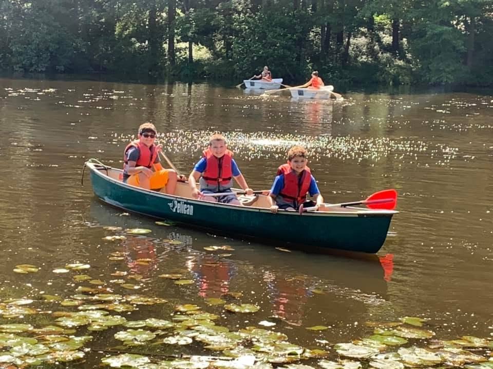 Scouts paddling a canoe at Camp Seton
