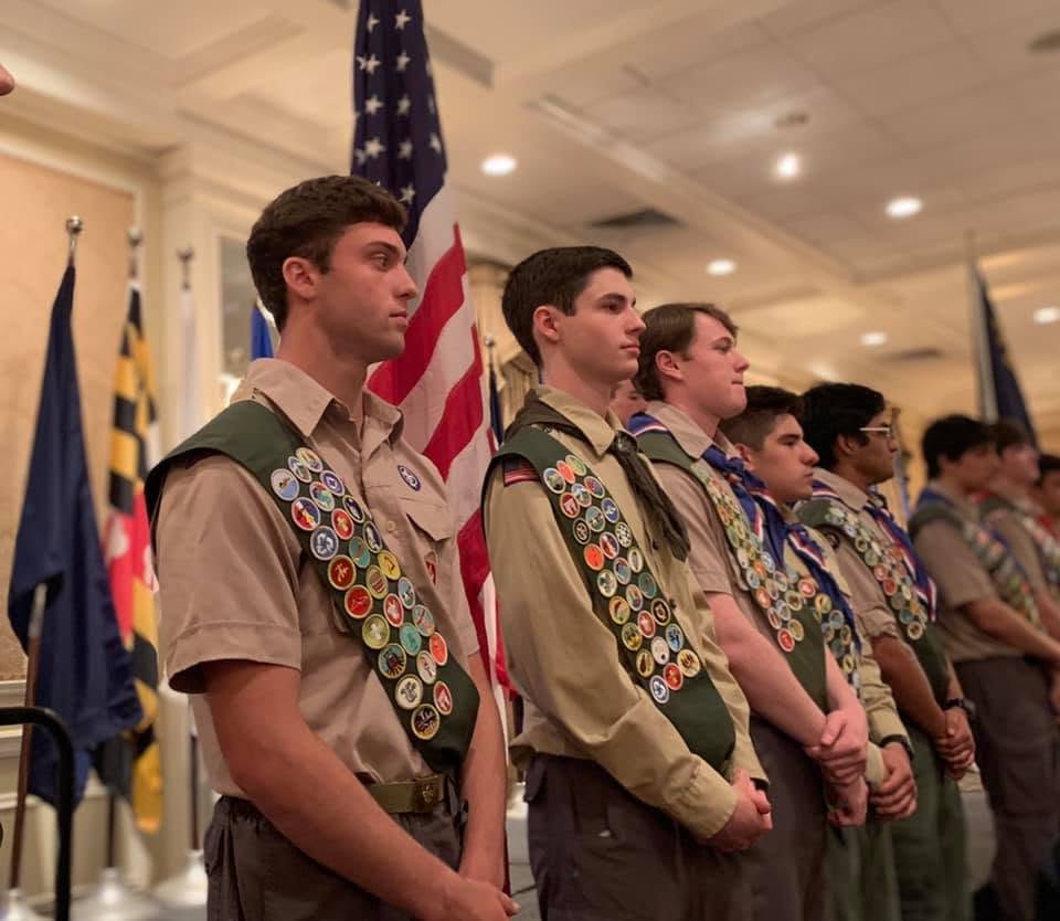 Eagle Scouts standing in uniform at a Greenwich Council ceremony